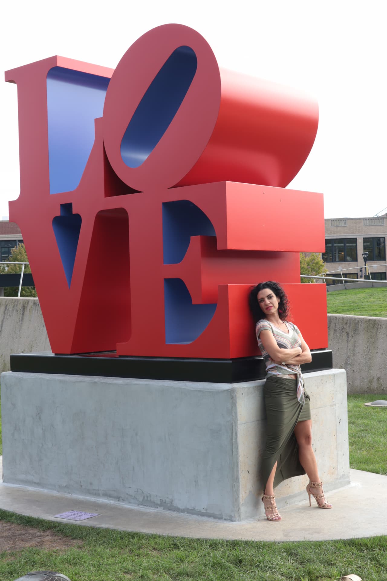 Heidi L. Wilson beside a large red LOVE sculpture